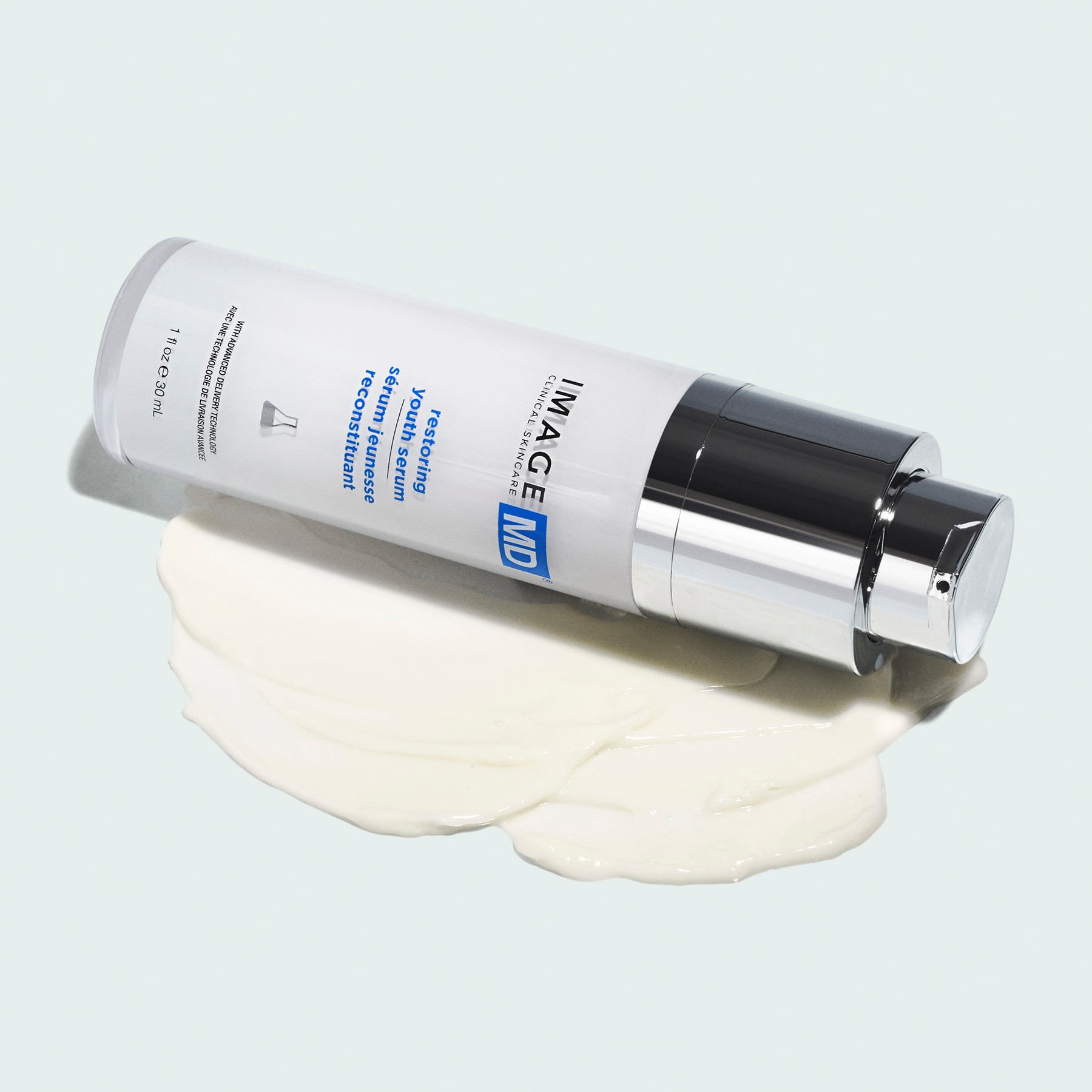 bottle of IMAGE MD restoring youth serum laid down on texture shot 