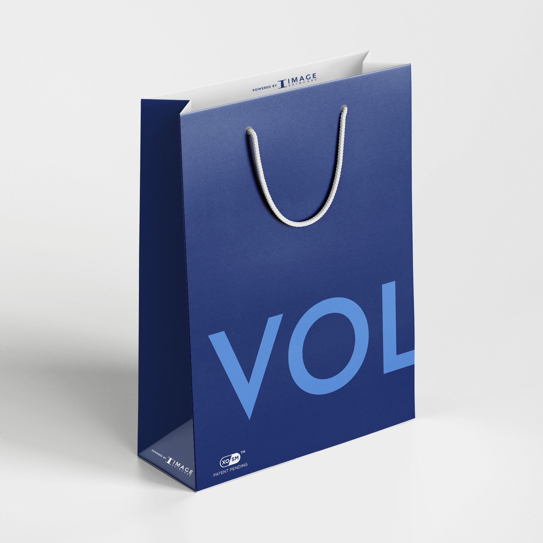 Blue shopping bag with 'VOL' printed on it against a white background